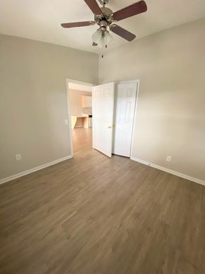 Nashville apartment for rent - an empty living room with wooden floors and a ceiling fan