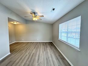 Rocky Mount apartment for rent - A room with a ceiling fan and a window with blinds.