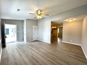 Rocky Mount apartment for rent - A spacious room with a ceiling fan and lighting fixture.