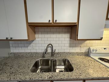 Nashville apartment for rent - a kitchen with a sink and white cabinets