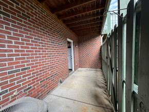 Nashville apartment for rent - a brick hallway with a door to a brick building