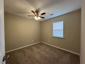 Nashville apartment for rent - an empty bedroom with a ceiling fan and a window