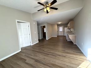 Nashville apartment for rent - A room with a ceiling fan and wooden flooring.