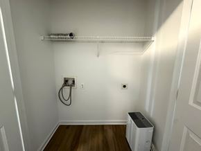 Nashville apartment for rent - A white wall with a shelf and a wall outlet.