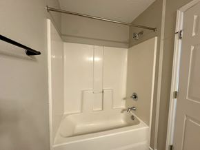 Nashville apartment for rent - A white bathtub with a shower head and faucet.