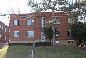Cincinnati apartment for rent - A red brick building with a tree in front of it.
