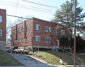 Cincinnati apartment for rent - A red brick building with a truck parked in front.