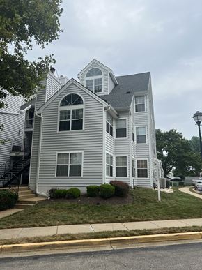 Laurel house for rent - A two-story house with a grey siding exterior.