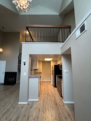 Laurel house for rent - A large open living space with a staircase leading to the upper floor.