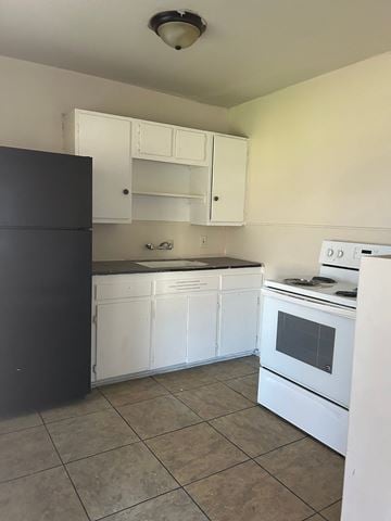 Killeen apartment for rent - an empty kitchen with white appliances and white cabinets