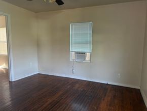 Killeen apartment for rent - an empty room with wood floors and an air conditioner on the wall