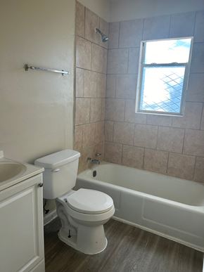 Killeen apartment for rent - a bathroom with a toilet and a tub and a window