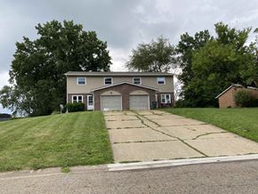 Massillion apartment for rent - A house with a garage and a driveway in front of it.