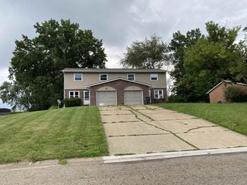 Massillion apartment for rent - A house with a garage and a driveway in front of it.