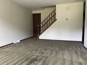 Massillion apartment for rent - A room with a carpeted floor and a staircase.