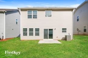 Charlotte house for rent - A FirstKey homes sign is on a grassy area in front of a building.
