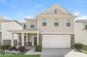 Charlotte house for rent - a beige house with a white garage door