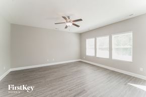 Charlotte house for rent - a living room with wood floors and a ceiling fan