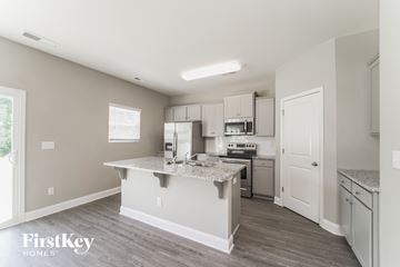 Charlotte house for rent - a white kitchen with a granite counter top and