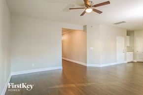 Charlotte house for rent - A room with a ceiling fan and wooden flooring.