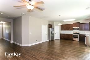 Charlotte house for rent - A spacious kitchen and living room with wooden floors and a ceiling fan.