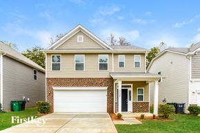 Charlotte house for rent - A two-story house with a garage is for sale.