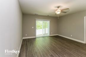 Charlotte house for rent - A room with a sliding glass door leading to a balcony.