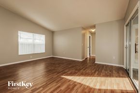Riverview house for rent - an empty living room with wood flooring and a window