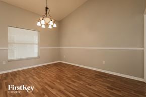 Riverview house for rent - the living room of an empty house with wood floors and a window