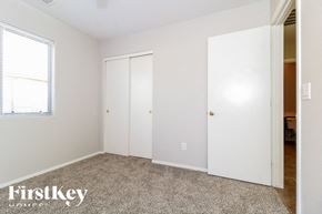 Buckeye house for rent - a bedroom with two closets and a carpeted floor