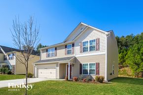 Winston Salem house for rent - a beige house with red shutters and a lawn