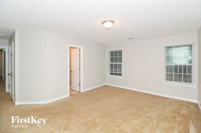 Buford house for rent - a bedroom with a carpeted floor and a door to a closet