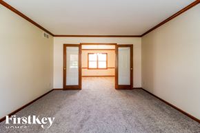 West Chester house for rent - A room with a carpeted floor and a window with sunlight shining through.