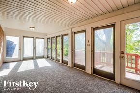 West Chester house for rent - A sunny day in a house with a balcony and a view of the trees.