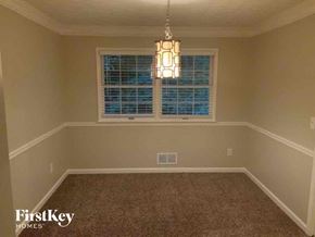 Lithonia house for rent - an empty dining room with a window and a chandelier