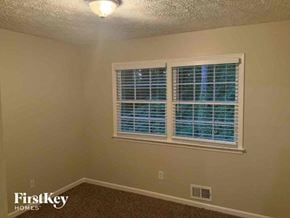 Lithonia house for rent - a bedroom with a window and a lamp on the ceiling