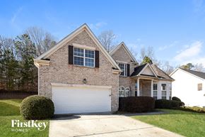 College Park house for rent - a brick house with a white garage door in front of it