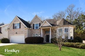 College Park house for rent - a large brick house with a lawn in front of it