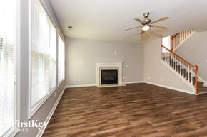 College Park house for rent - a living room with wood flooring and a fireplace
