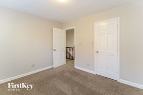 Kernersville house for rent - a bedroom with two doors and a carpeted floor