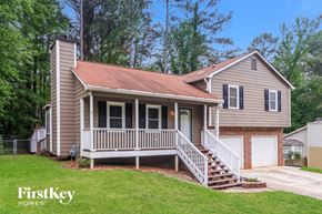 Kennesaw house for rent - A house with a porch and a garage door is for sale.