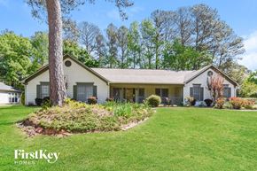 Marietta house for rent - a white house with a lawn and a tree