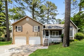 Marietta house for rent - a tan house with a white garage door
