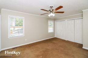 Marietta house for rent - a bedroom with carpet and a ceiling fan