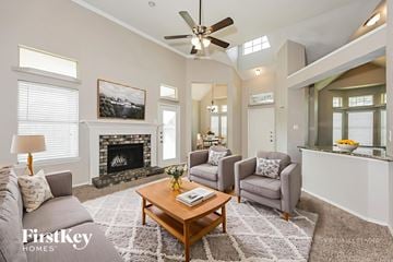 Mesquite house for rent - A living room with a fireplace and a painting on the wall.