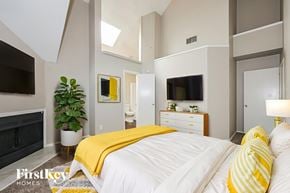 Mesquite house for rent - A bedroom with a bed covered in a yellow blanket.