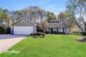 Powder Springs house for rent - A house with a garage and a driveway in front of it.
