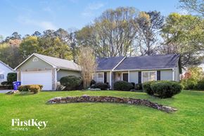 Powder Springs house for rent - A house with a stone wall in front of it.