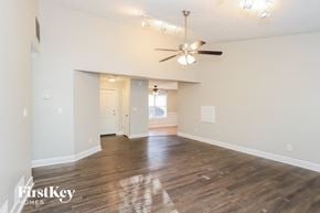 Powder Springs house for rent - A spacious room with a ceiling fan and wooden flooring.