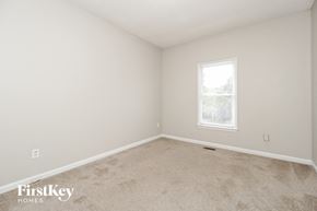 Powder Springs house for rent - a bedroom with white walls and carpet and a window